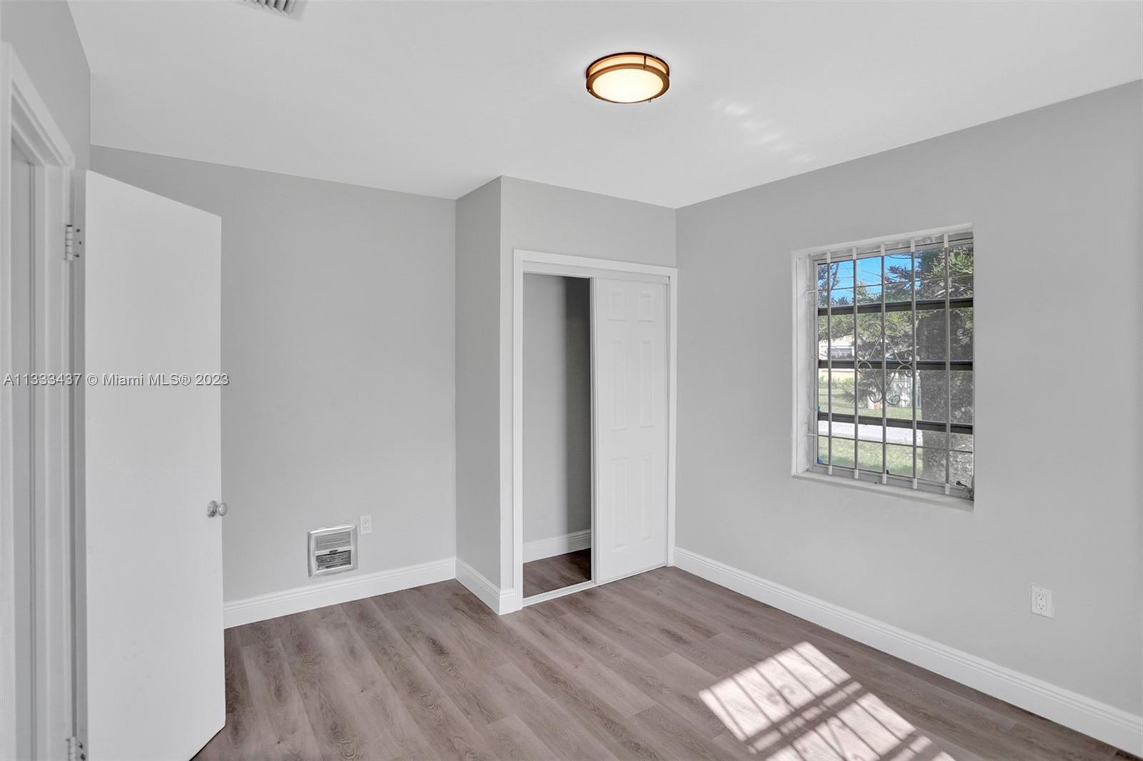 1101 Northwest 147th Street Miami, FL 33168 - Photo 21 of 45 an empty room with windows