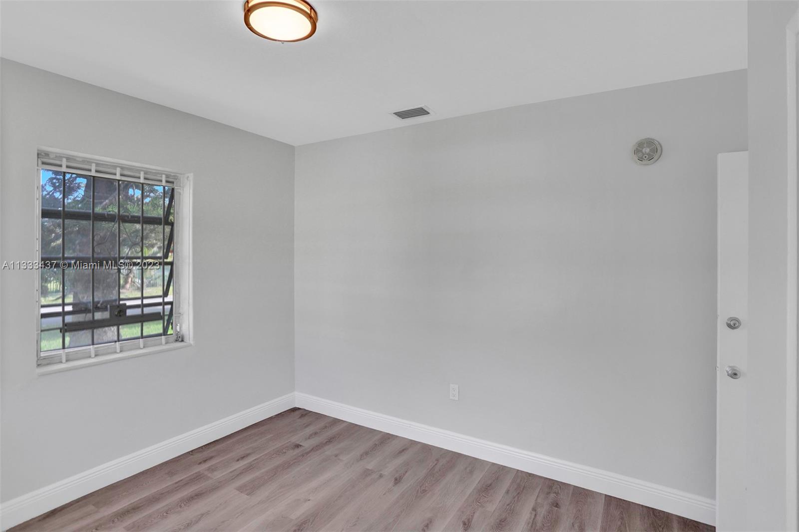1101 Northwest 147th Street Miami, FL 33168 - Photo 25 of 45 an empty room with windows and closet