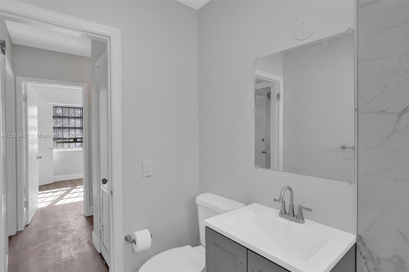 1101 Northwest 147th Street Miami, FL 33168 - Photo 27 of 45 a bathroom with a sink toilet and vanity