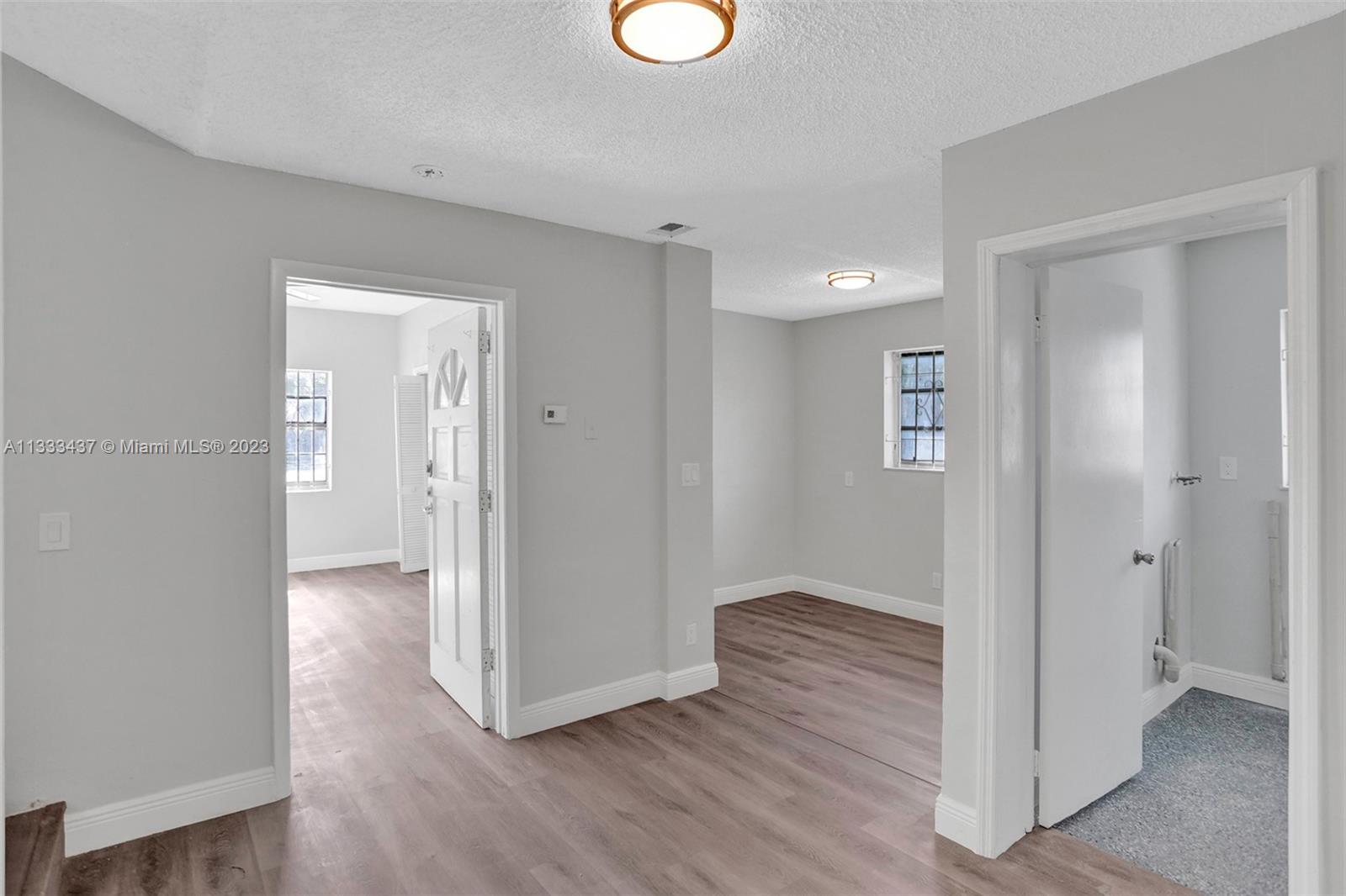 1101 Northwest 147th Street Miami, FL 33168 - Photo 29 of 45 a view of entryway with wooden floor