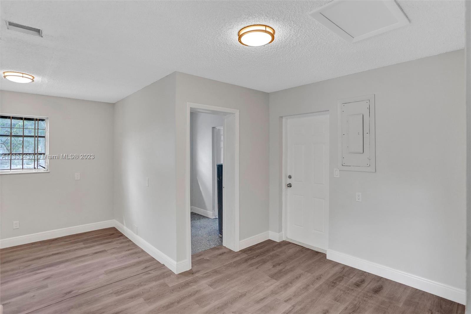 1101 Northwest 147th Street Miami, FL 33168 - Photo 30 of 45 an empty room with wooden floor and windows