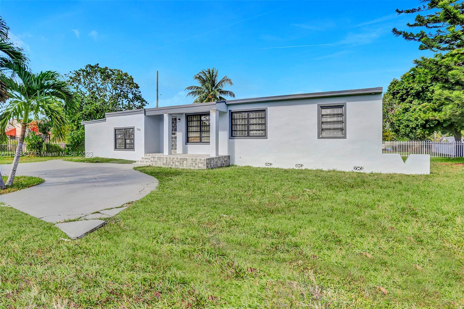 1101 Northwest 147th Street Miami, FL 33168 - Photo 3 of 45 a front view of house with yard and green space
