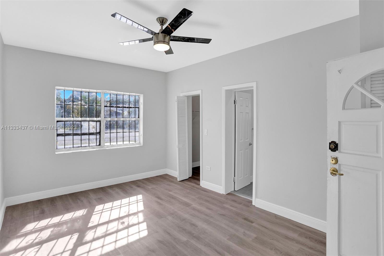1101 Northwest 147th Street Miami, FL 33168 - Photo 34 of 45 a view of a livingroom with a window and wooden floor