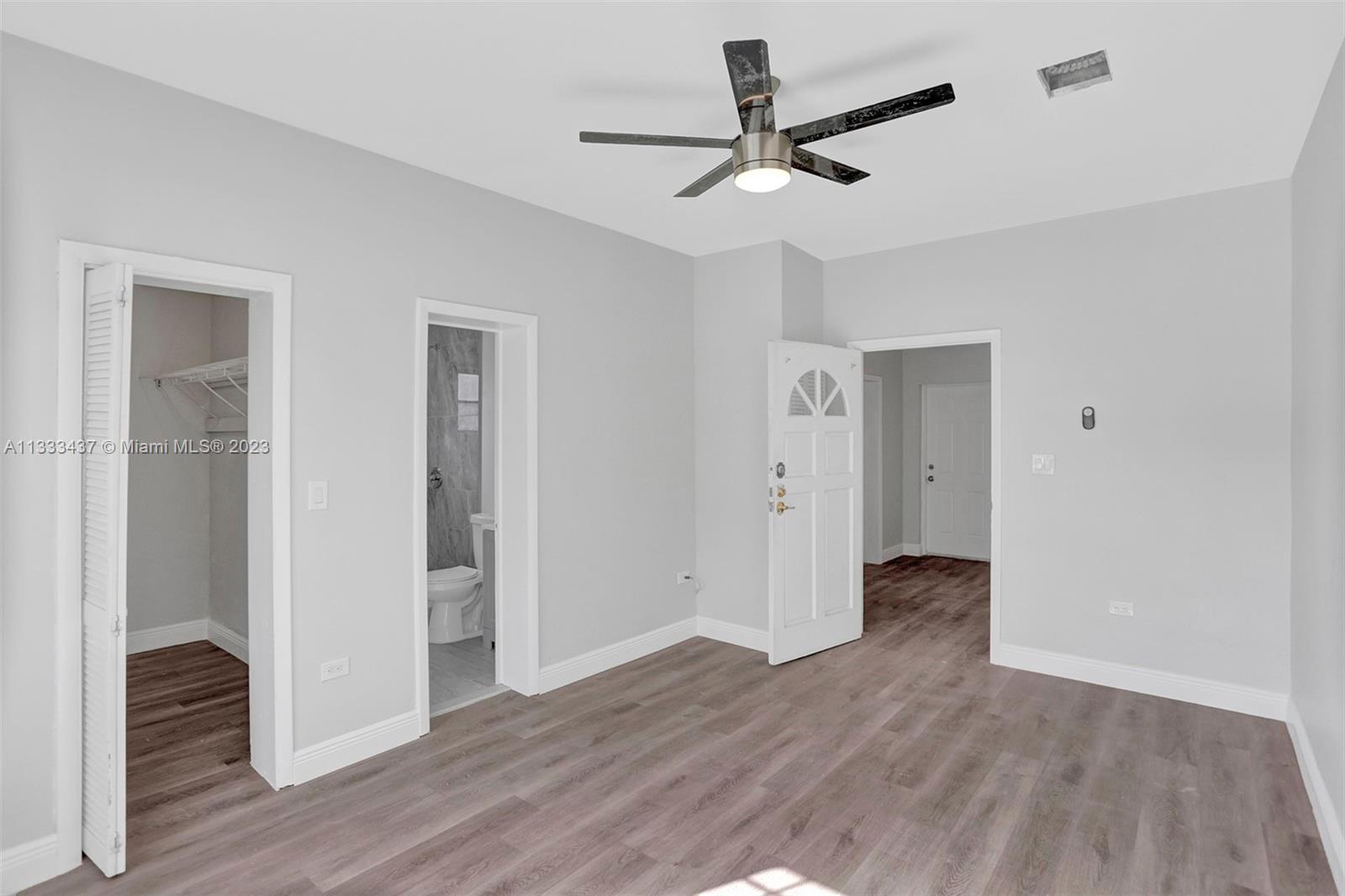 1101 Northwest 147th Street Miami, FL 33168 - Photo 35 of 45 a view of a livingroom with wooden floor and a ceiling fan