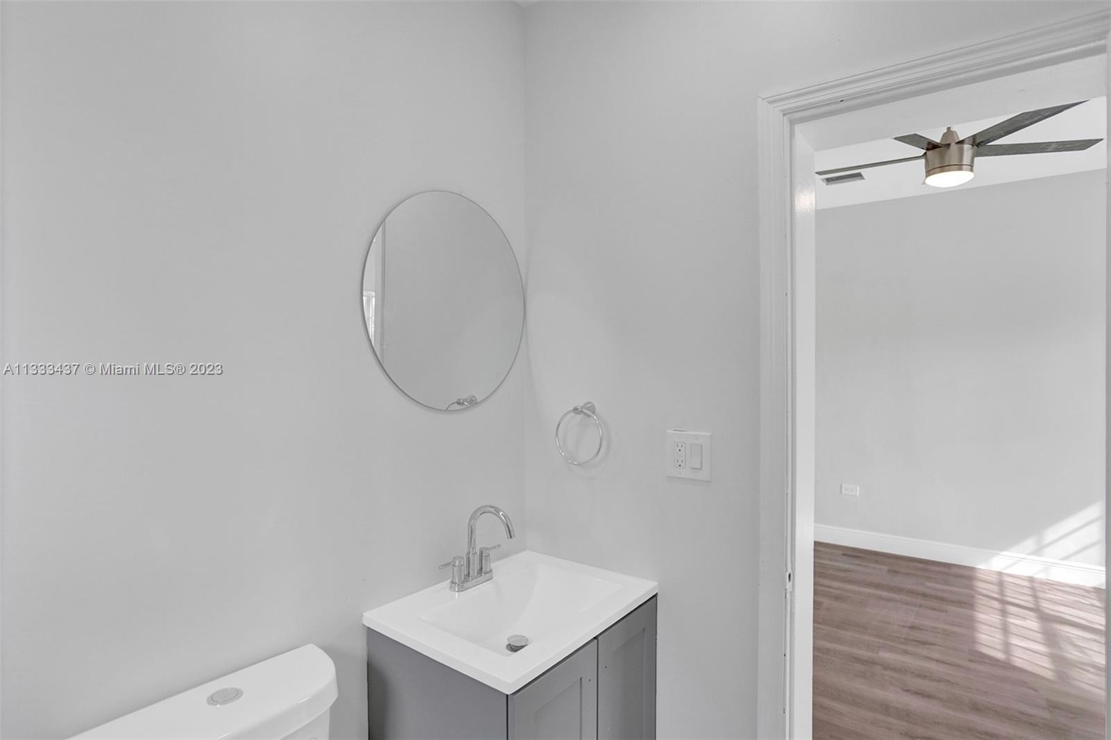 1101 Northwest 147th Street Miami, FL 33168 - Photo 39 of 45 a bathroom with a toilet a sink and mirror