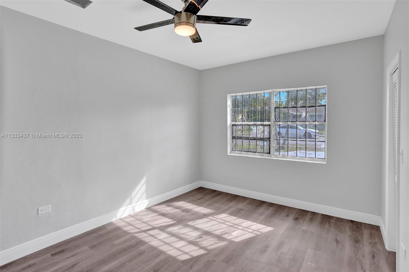 1101 Northwest 147th Street Miami, FL 33168 - Photo 40 of 45 a view of an empty room with wooden floor and a window