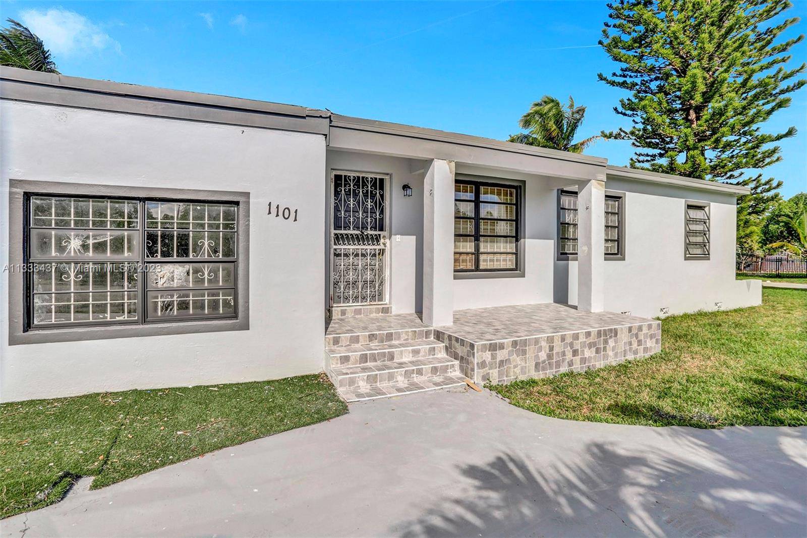 1101 Northwest 147th Street Miami, FL 33168 - Photo 4 of 45 front view of a house with a small yard