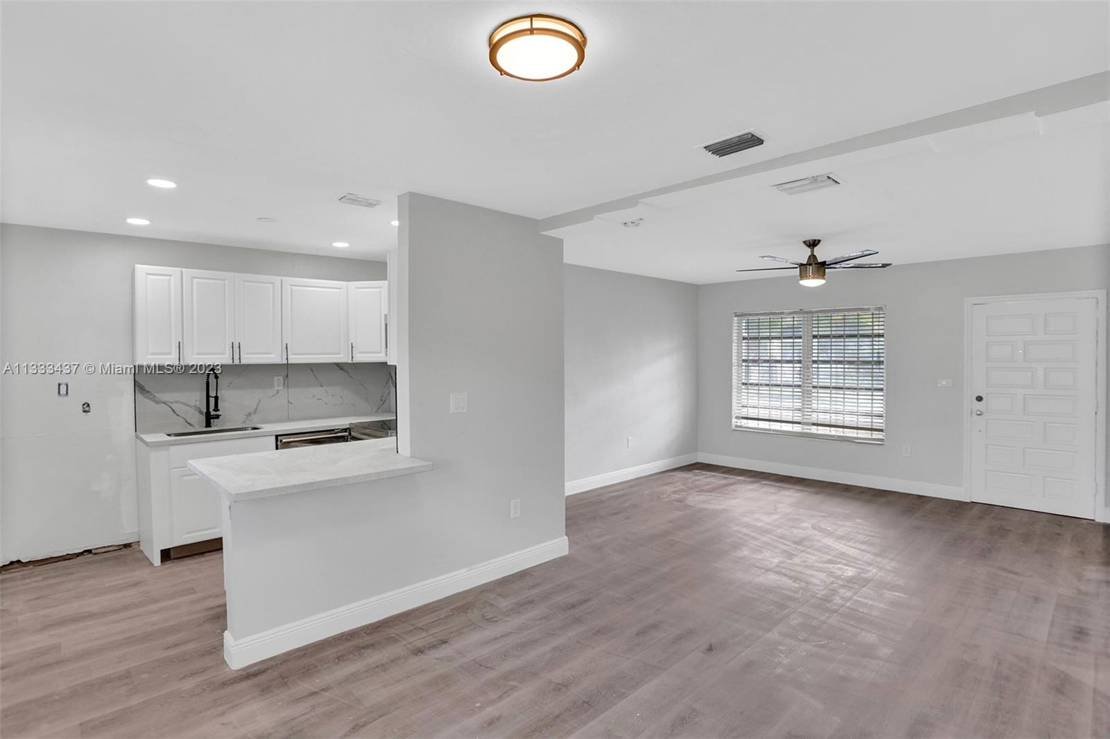 1101 Northwest 147th Street Miami, FL 33168 - Photo 5 of 45 a view of kitchen with a sink dishwasher and a refrigerator