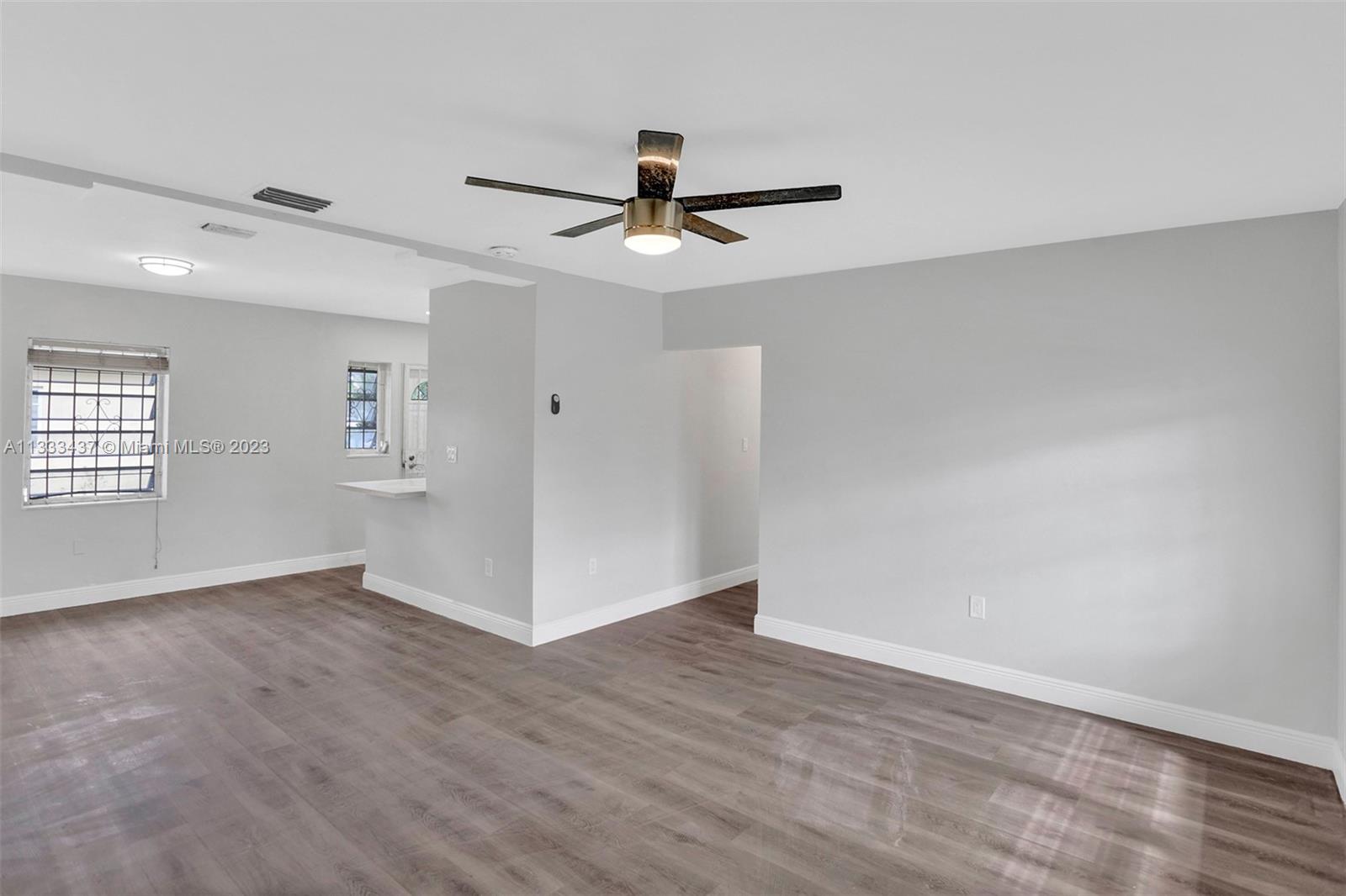 1101 Northwest 147th Street Miami, FL 33168 - Photo 6 of 45 an empty room with windows and fan