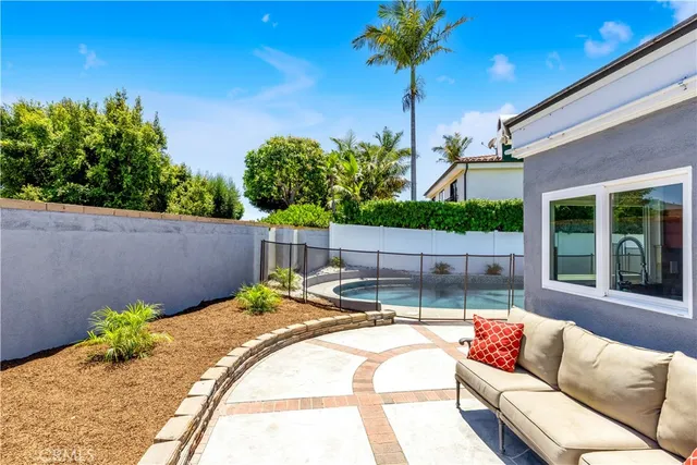 a view of a house with pool and sitting area