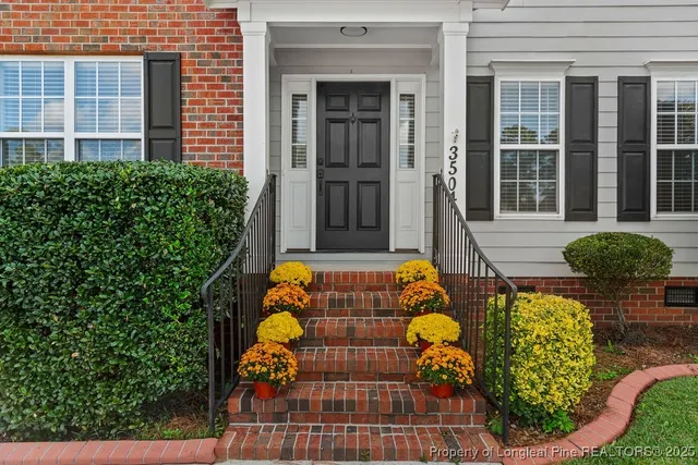 front view of house with a chairs and table in a patio
