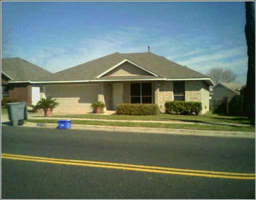 5602 Teri Road Austin, TX 78744 - Photo 1 of 1 a front view of a house with a garden and yard