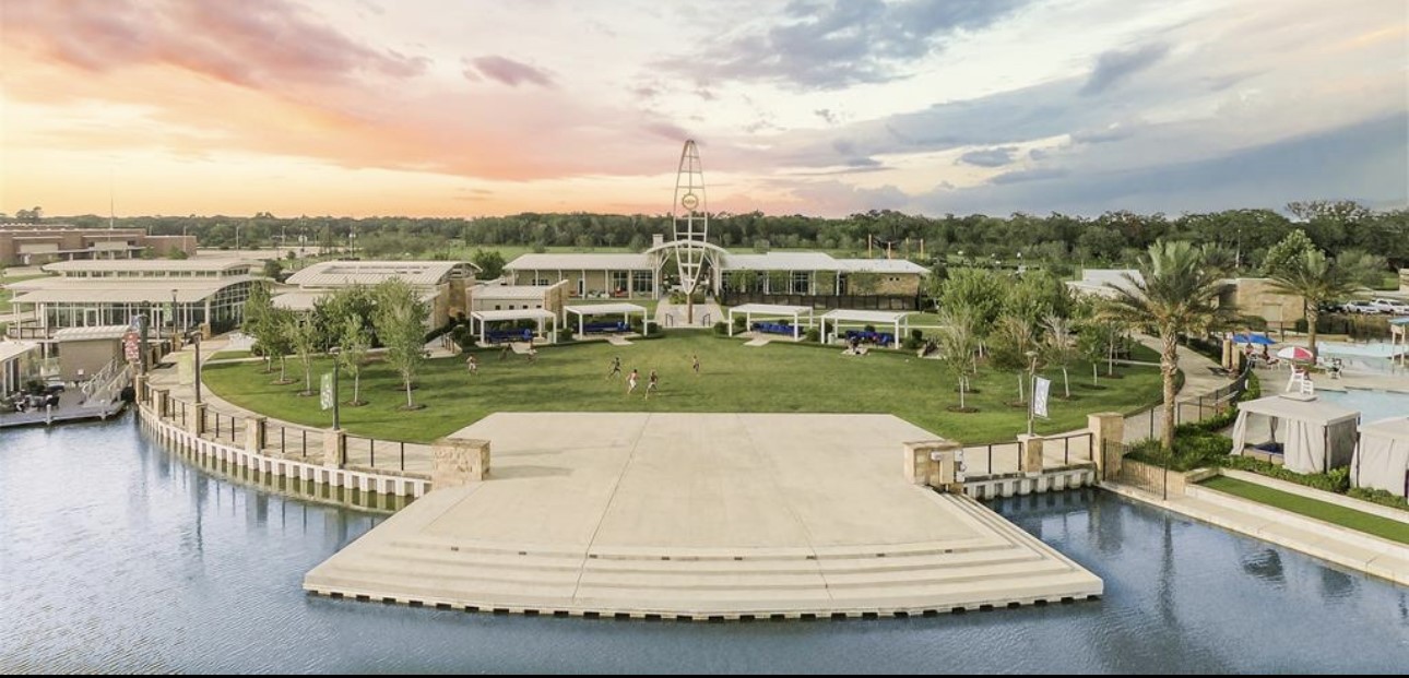 4143 Champlain Way Iowa Colony, TX 77583 - Photo 24 of 28 a view of a lake with a garden