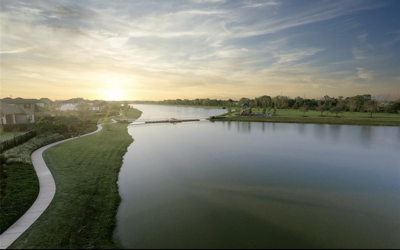 4143 Champlain Way Iowa Colony, TX 77583 - Photo 25 of 28 a view of a lake with a city