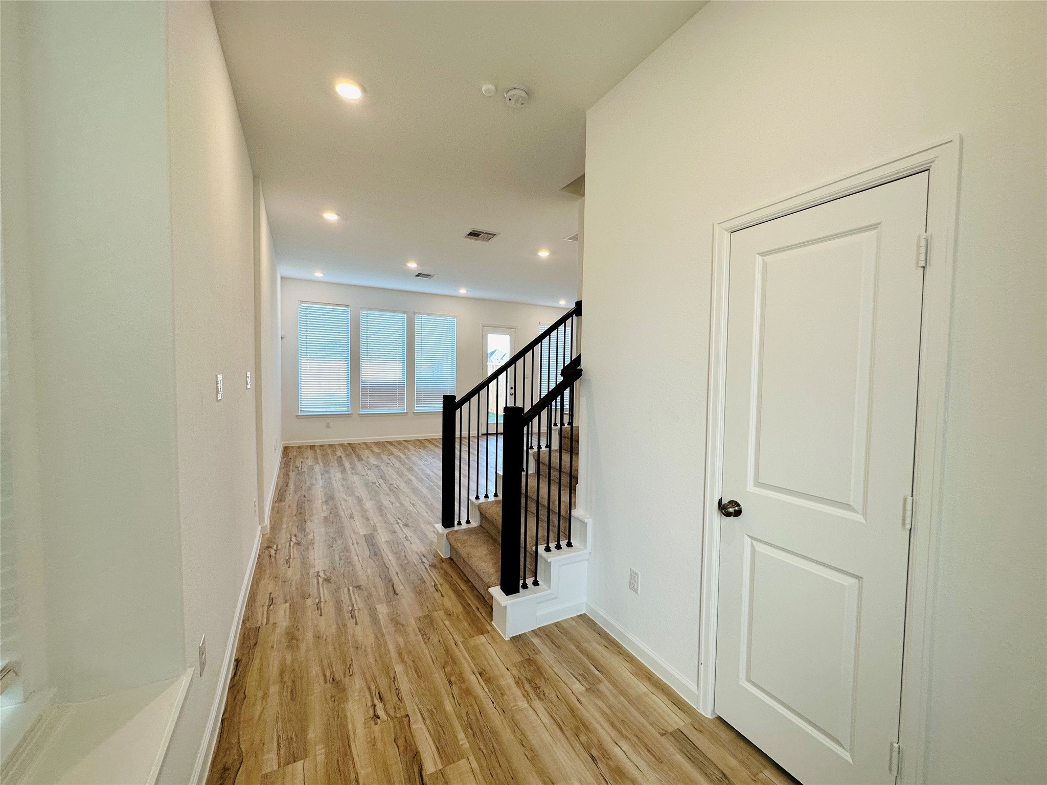 4143 Champlain Way Iowa Colony, TX 77583 - Photo 4 of 28 a view of a hallway with wooden floor and staircase