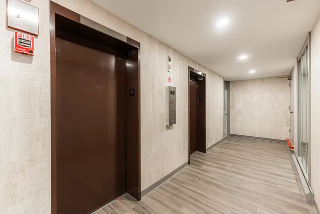 a view of hallway with wooden floor