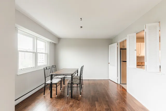 a view of a dining room with furniture and wooden floor