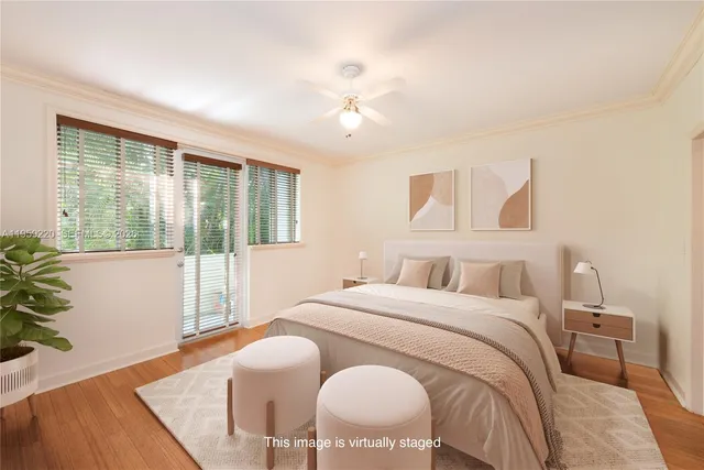 a bedroom with a large bed and a large window