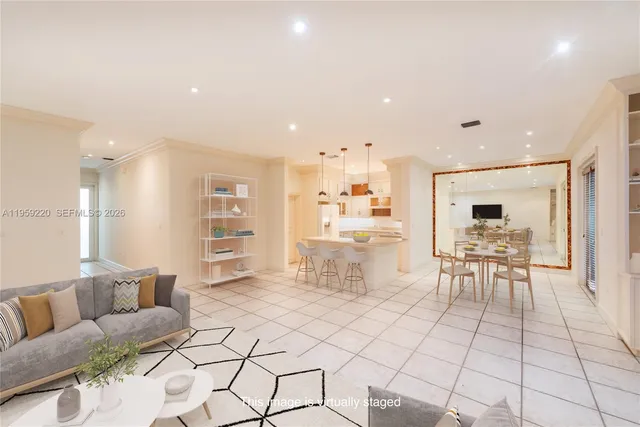 a living room with furniture and kitchen view