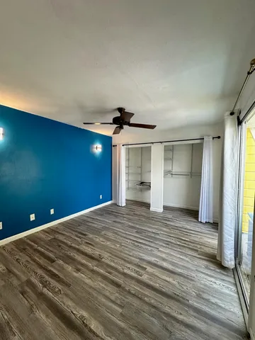 a view of a livingroom with wooden floor and closet