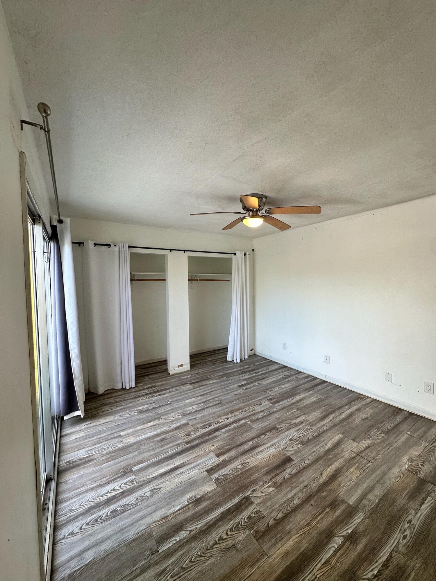 3210 Eagle Avenue Key West, FL 33040 - Photo 19 of 35 an empty room with wooden floor and windows