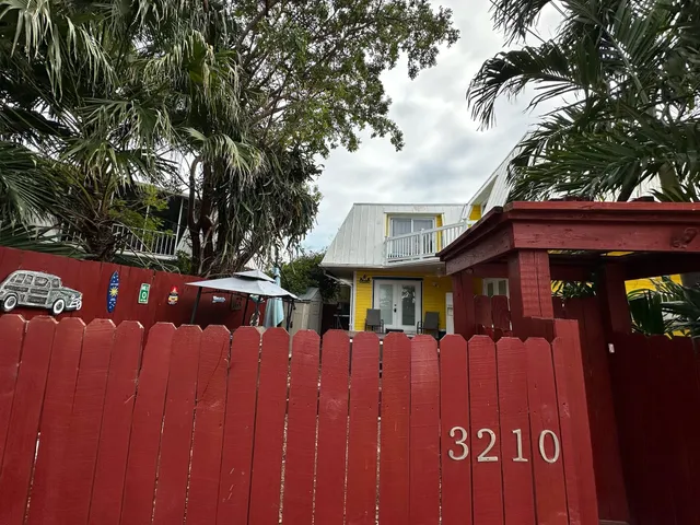 a view of a house with a wooden fence