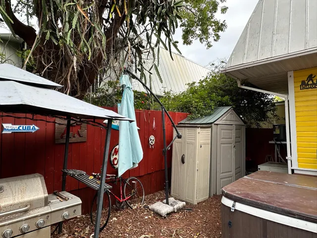 a view of a backyard with furniture and a grill