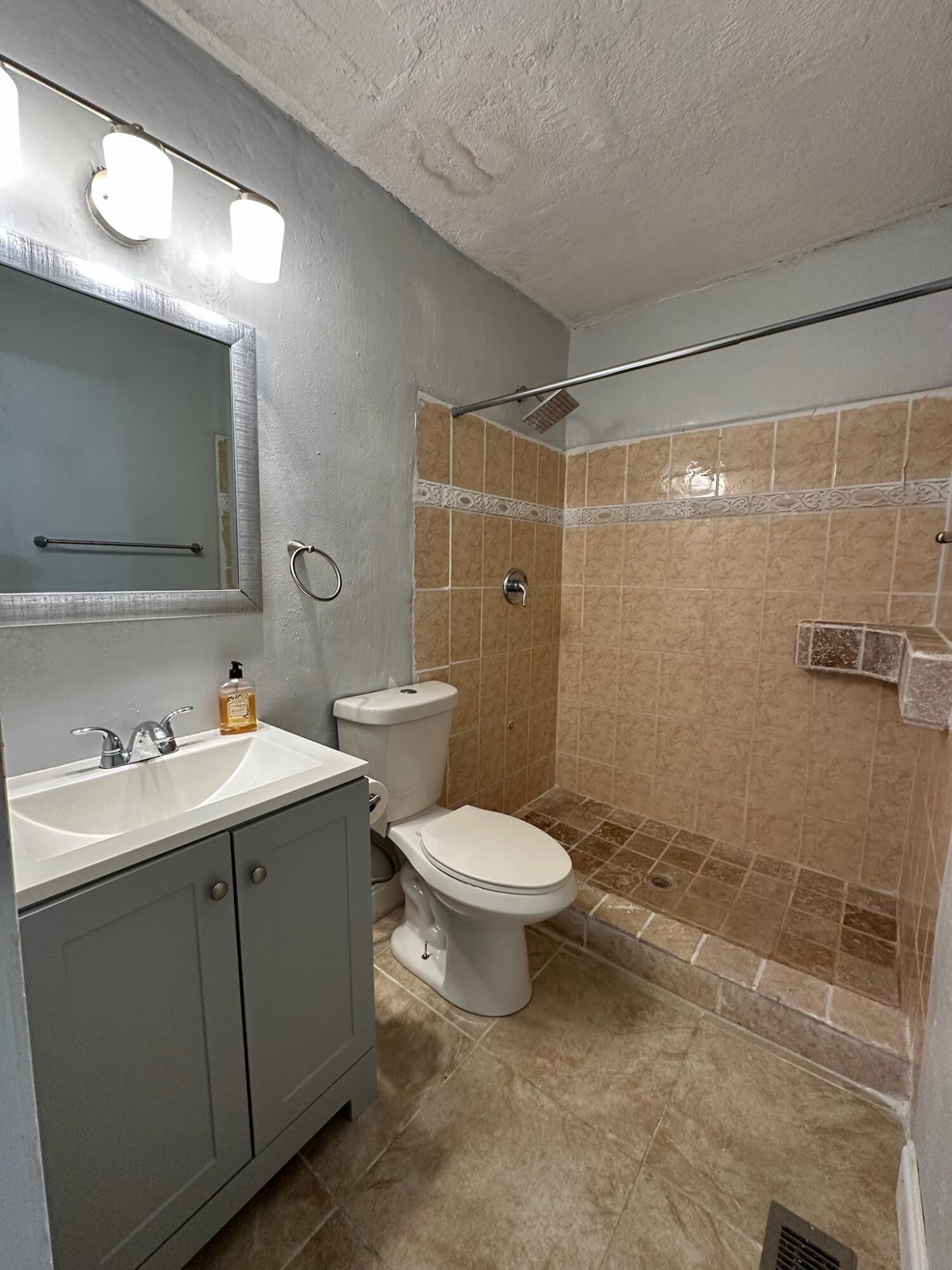3210 Eagle Avenue Key West, FL 33040 - Photo 24 of 35 a bathroom with a toilet sink shower and mirror
