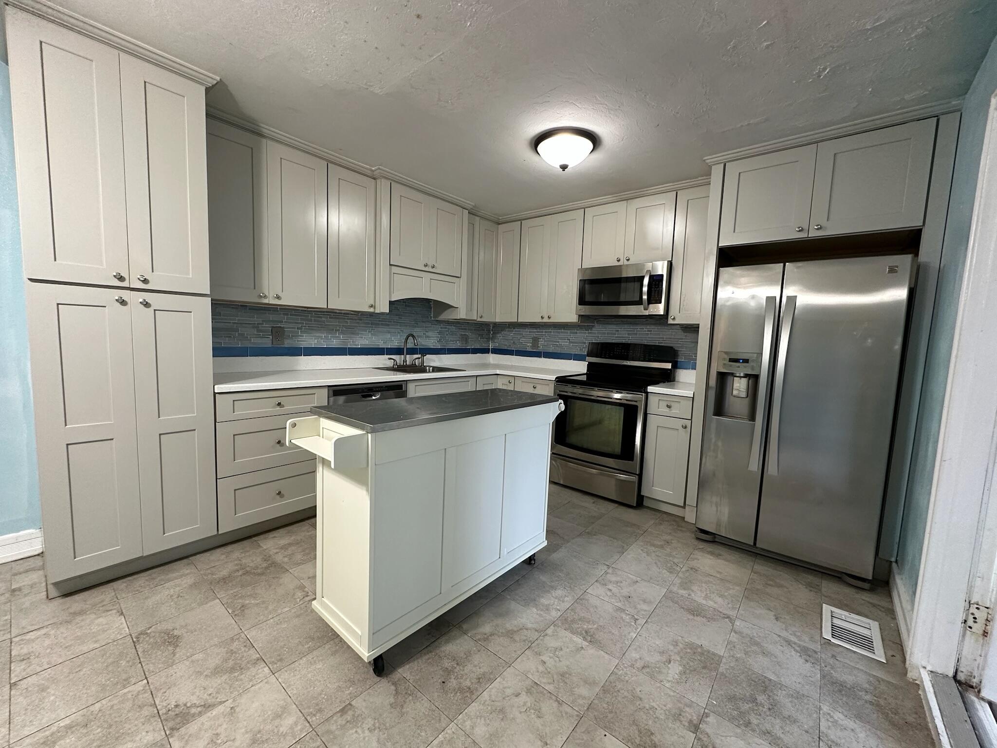 3210 Eagle Avenue Key West, FL 33040 - Photo 6 of 35 a kitchen with cabinets and stainless steel appliances