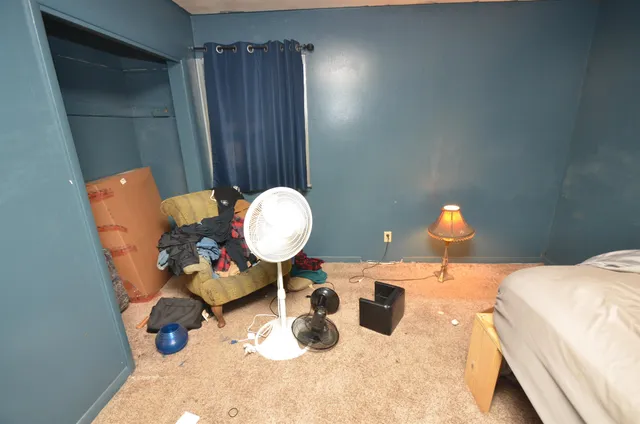 a bed room with a bed and a chandelier