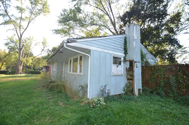 a front view of house with yard and trees