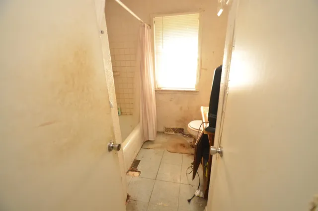 a bathroom with a tub and a shower