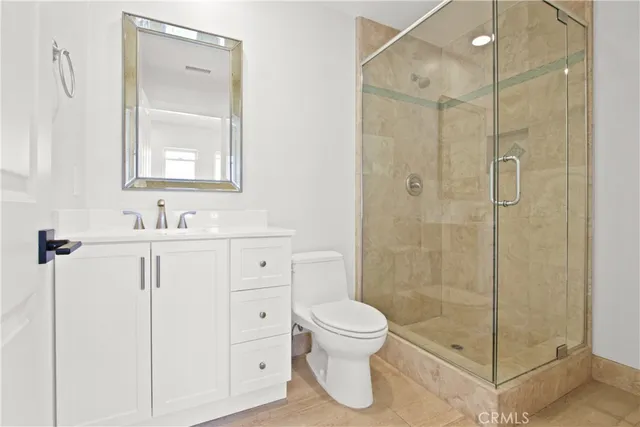 a bathroom with a shower toilet sink and mirror