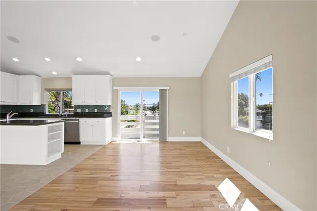a view of kitchen with wooden floor and electronic appliances