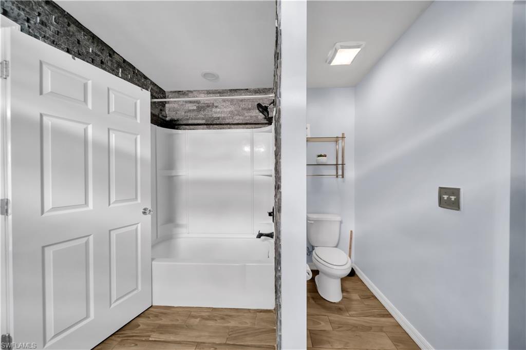 175 Shadowview Court Lehigh Acres, FL 33974 - Photo 24 of 39 a bathroom with a granite countertop shower and a toilet