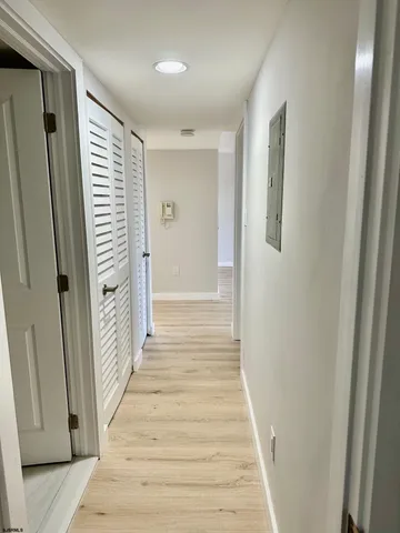 a view of a hallway with wooden floor and staircase