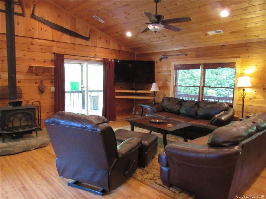 405 Front Ridge Circle, Unit 62 Rutherfordton, NC 28139 - Photo 13 of 30 a living room with furniture a large window and a flat screen tv