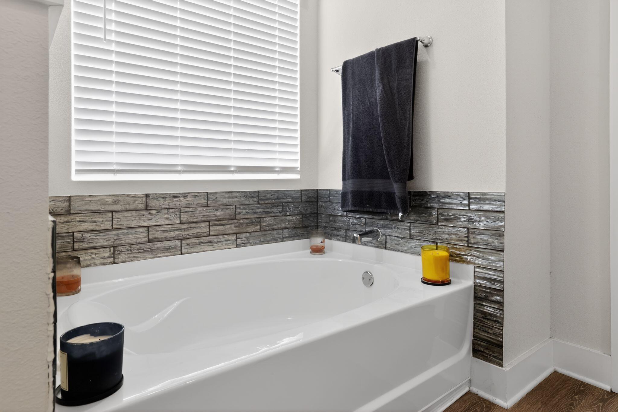 2452 Dakota Way Crestview, FL 32536 - Photo 18 of 24 a bathroom with a tub a sink and a window