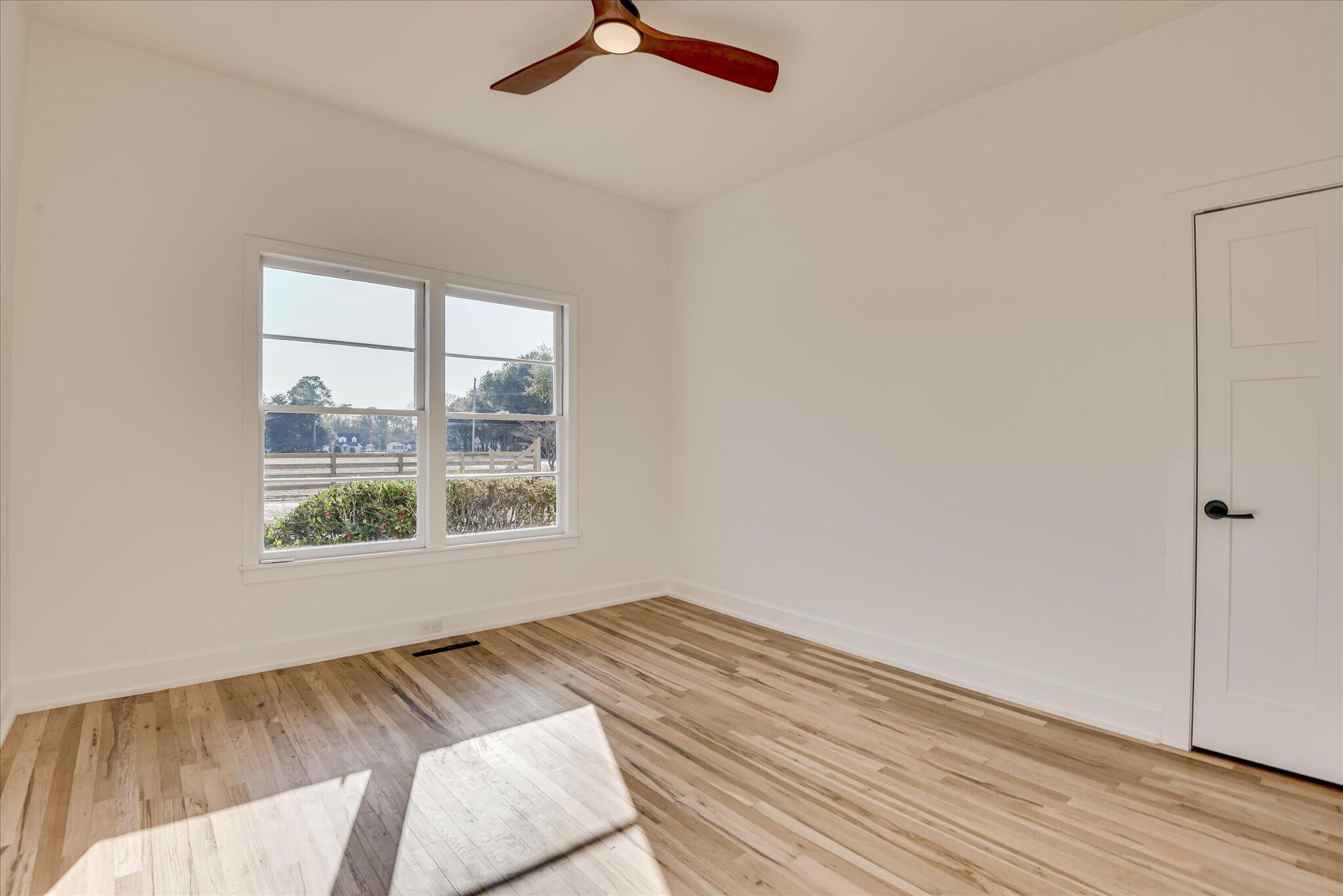 126 Mosley Road Aiken, SC 29801 - Photo 23 of 29 a view of an empty room with wooden floor and a window