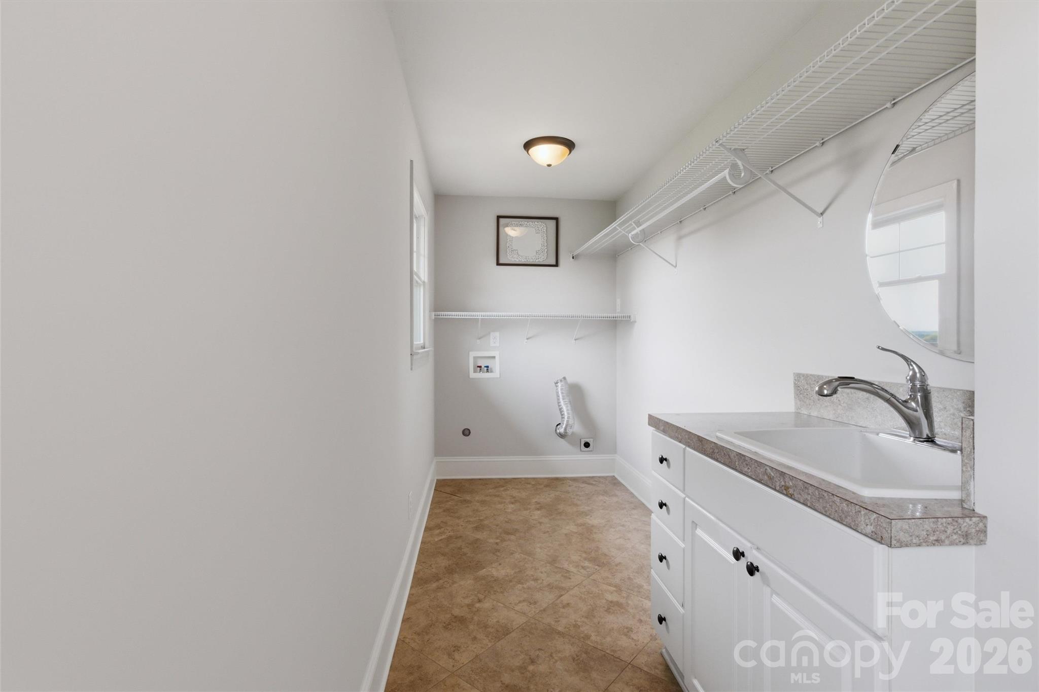 4712 Secrest Short Cut Road Monroe, NC 28110 - Photo 26 of 30 a bathroom with a sink and a mirror