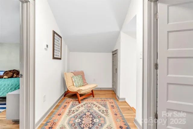a bedroom with furniture and a flat screen tv