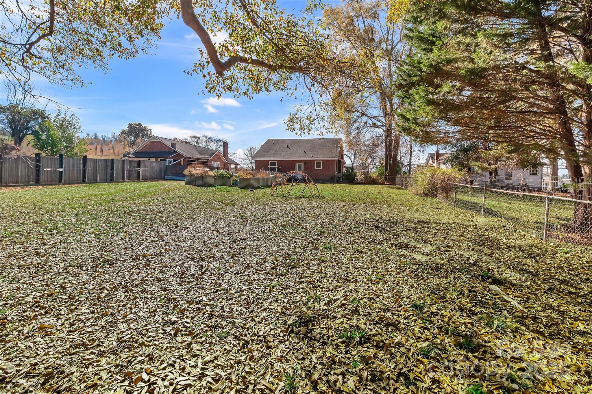 113 Marion Street Clover, SC 29710 - Photo 22 of 26 a garden with trees in front of it
