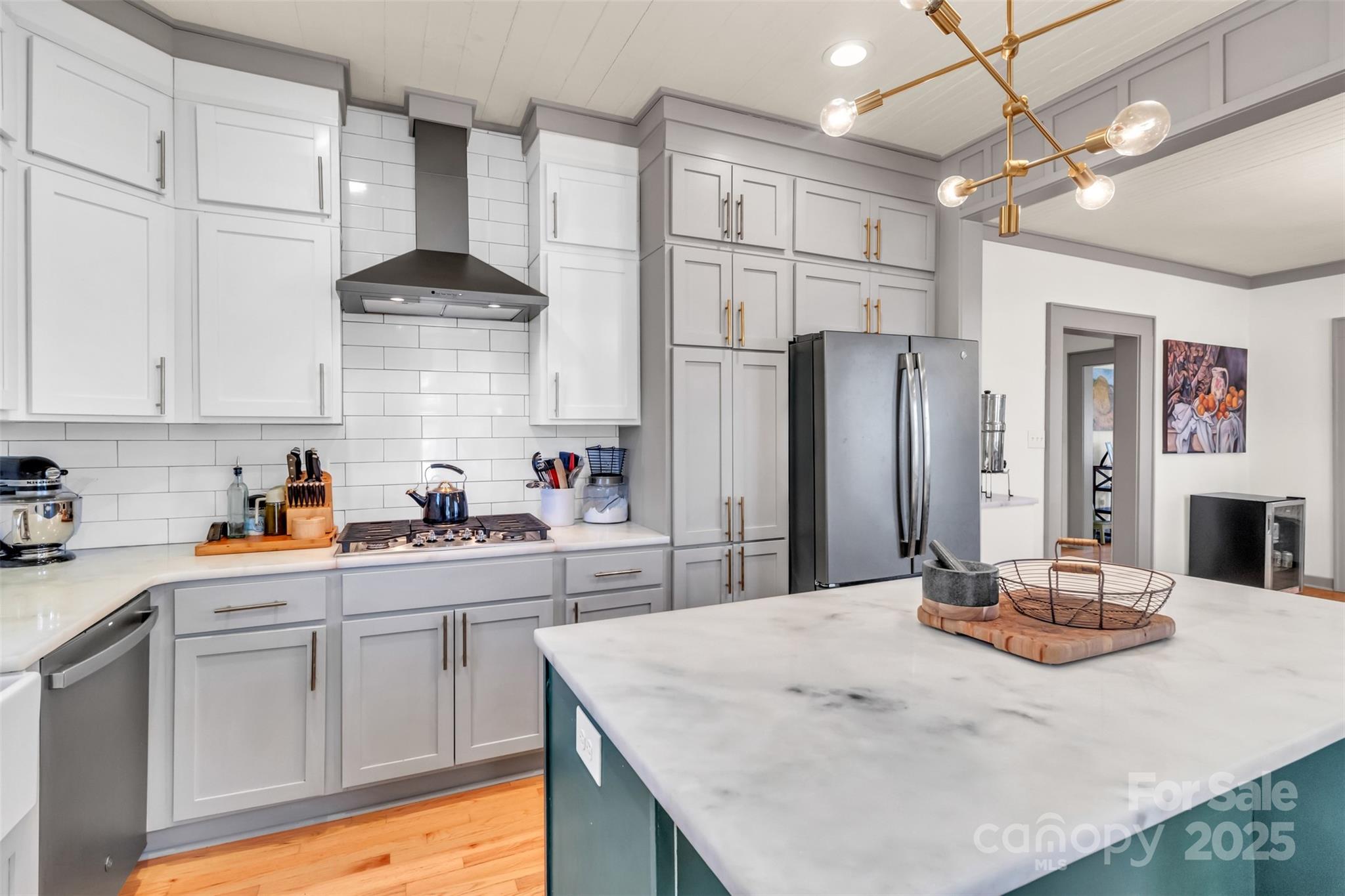 113 Marion Street Clover, SC 29710 - Photo 6 of 26 a kitchen with stainless steel appliances kitchen island granite countertop a refrigerator a sink dishwasher and white cabinets with wooden floor