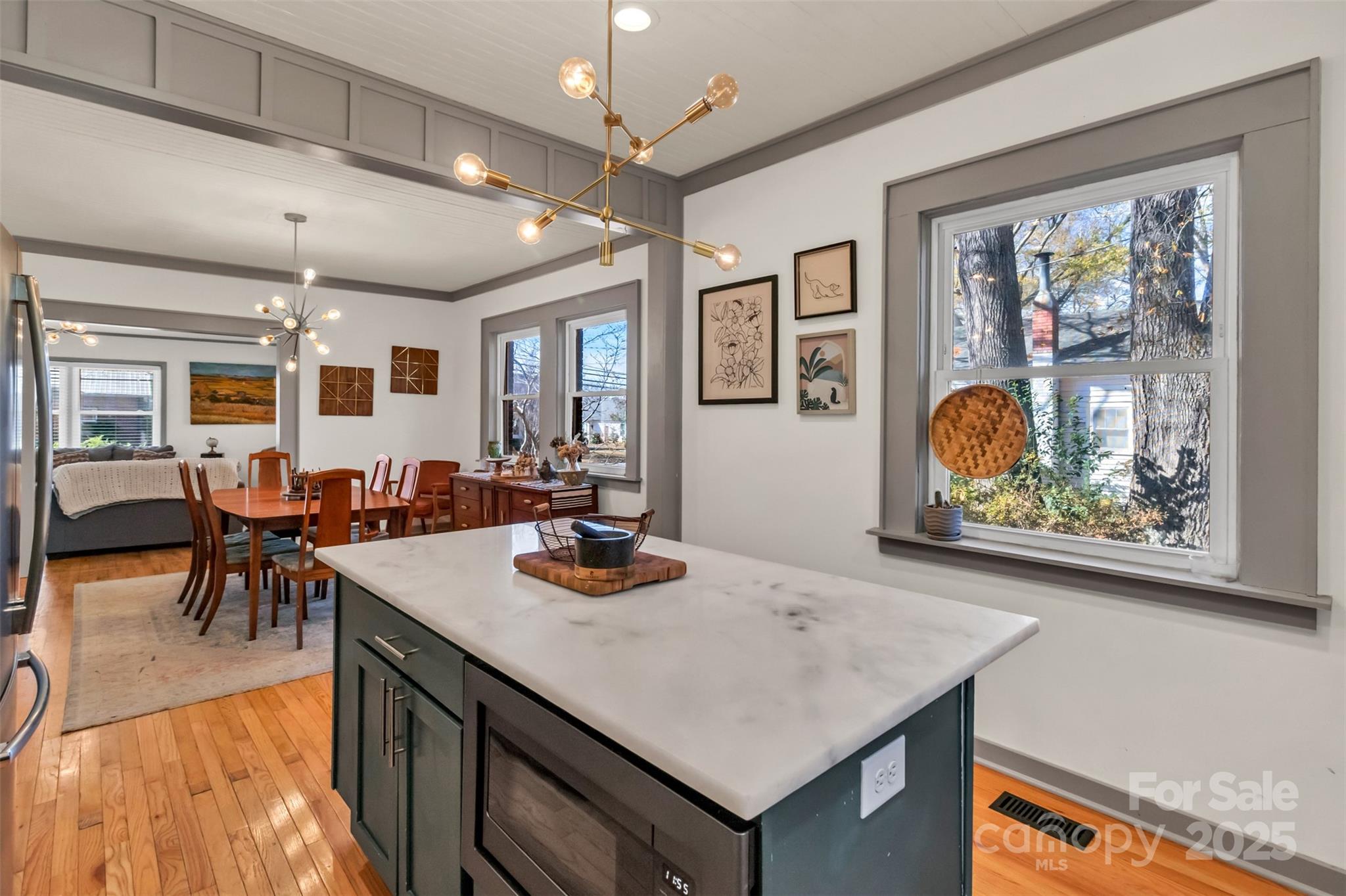 113 Marion Street Clover, SC 29710 - Photo 7 of 26 a view of kitchen island dining space wooden floor and living room