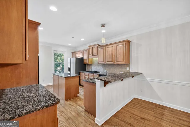 a kitchen with stainless steel appliances granite countertop a stove and a sink