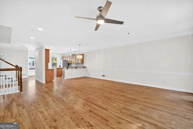 a view of empty room with wooden floor and window