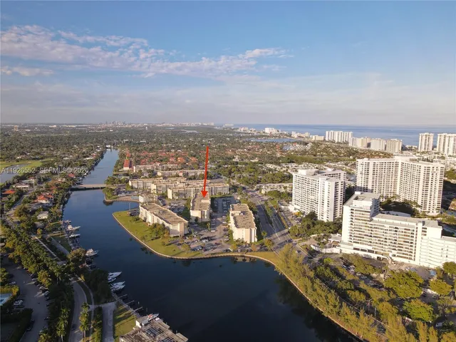 an aerial view of residential building and ocean view