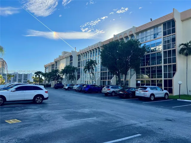 a view of a lake with boats and trees in the background