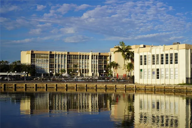 a front view of a house with a garden and plants