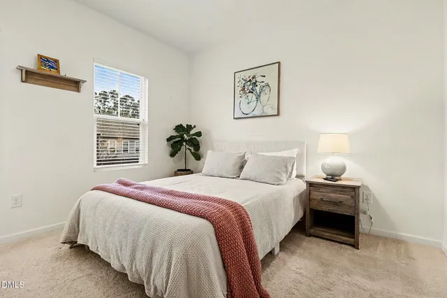 a bedroom with a bed and a lamp